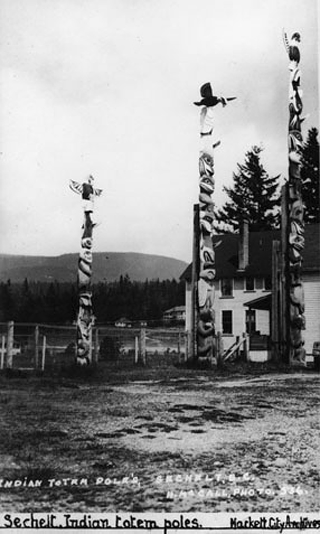 circa 1928-1929 -- Totem poles carved by Sechelt carver Dan Paull and Philip Paul Weenah of Rivers Inlet and commissioned by the Union Steamship Company. They stood outside the Sechelt Dance Pavilion and Totem Tea Room on the waterfront at Trail Bay until 1955 when they were removed to Bowen Island after the Union Steam Ship Company turned the village of Sechelt over to its residents in 1956.
Photograph # 5361 by Helen McCall, photograph courtesy the Vancouver City Archives